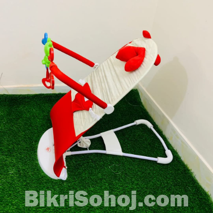 Automatic musical bouncer chair